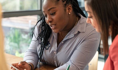 Two people looking over phone